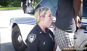 Une policière tire une bite en plein air